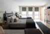 Guest bedroom with three beds, minimalist décor, and rustic-modern interior design in a Hudson Valley retreat.
