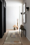Hudson Valley hallway with black wooden walls and shoe bench