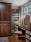 Custom millwork, wallpaper, and vintage art in this dressing room and walk in closet in historic home in West Chester New York
