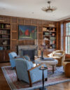 Coast heritage home library with vintage furniture and original wood panel walls