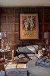 Sitting room with original wood paneling and modern art showcasing coastal interiors and heritage home design.