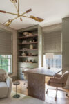 Contemporary Residence Short Hills home office with built-in green cabinetry, open shelving, desk, and statement lighting
