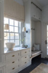 Custom mudroom with built-in bench, concealed storage, and floor-to-ceiling millwork in a luxury transitional home.
