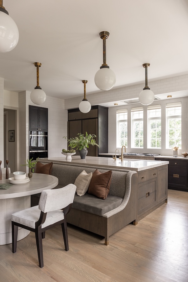 Open concept contemporary kitchen with custom cabinetry, island seating, and natural light