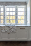 Transitional kitchen design with quartzite countertops, unlacquered brass hardware, and elegant custom cabinetry.