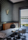 Cozy lounge corner with polka dot wallpaper and water views in a historic coastal Westchester home.
