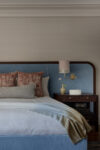 Primary bedroom in a coastal Westchester estate with soft blue palette and serene natural textures.
