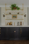 Marble bar counter with wood cabinetry and brass shelving in a Westfield NJ Tudor Revival home