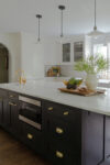Kitchen counter and marble island in a renovated Westfield Tudor Revival home with Tudor geometry and calm, modern design.