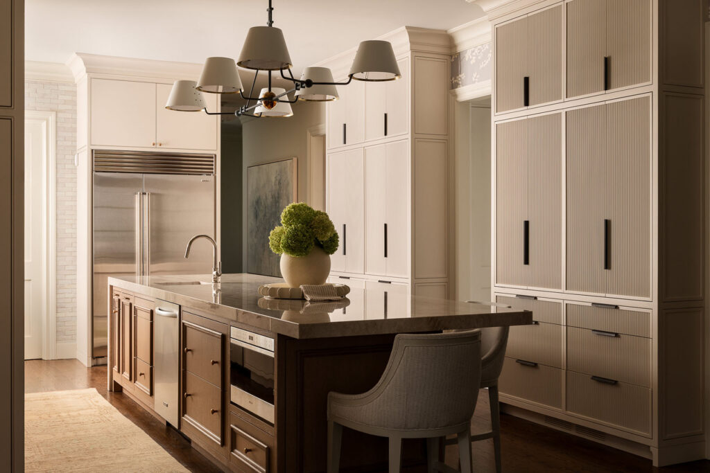 Luxury whole house renovation NJ kitchen with large island, built-in cabinetry, pendant lighting, and neutral tones in Westfield NJ residence