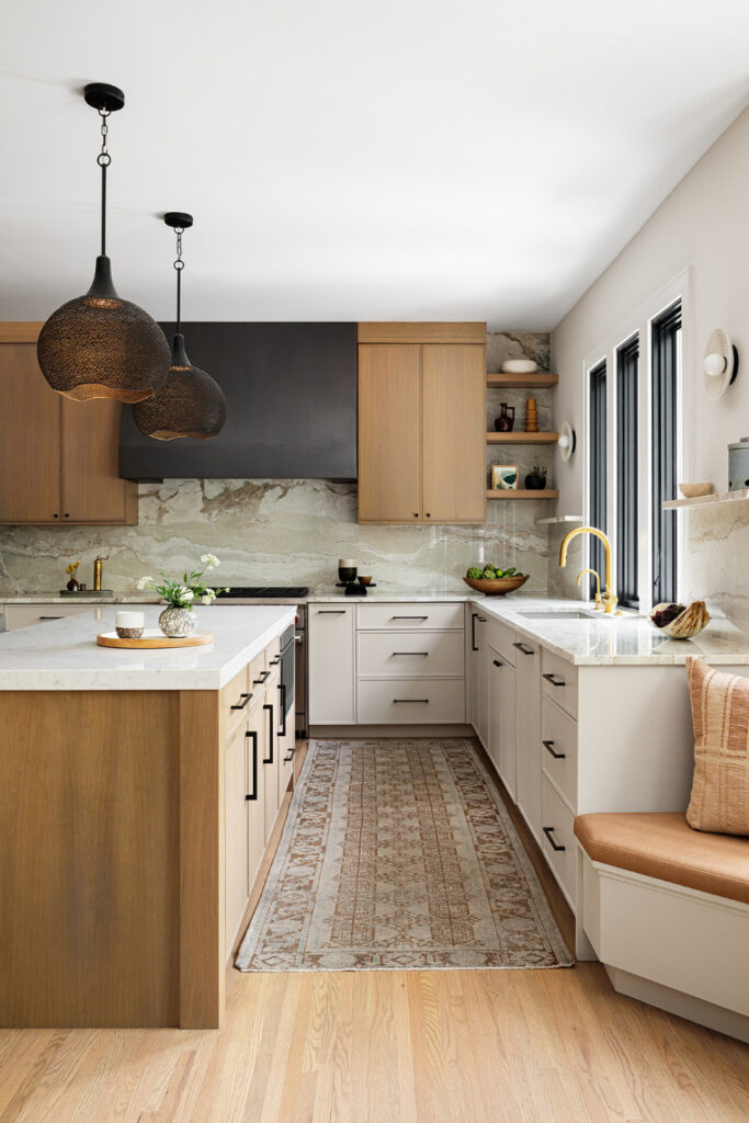 Contemporary kitchen with wood and white cabinetry, stone backsplash, kitchen island, pendant lighting, and built-in seating