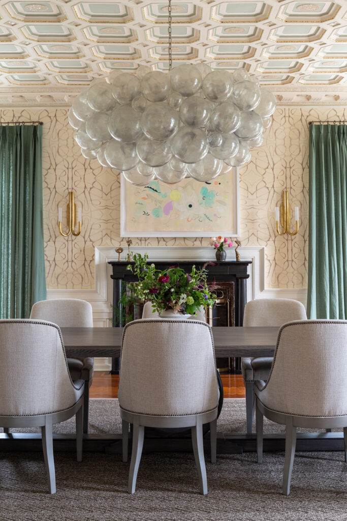Larchmont living room with hand-blown Murano glass orbs above preserved marble fireplace, highlighting Jazz Age interiors and Art Deco style.