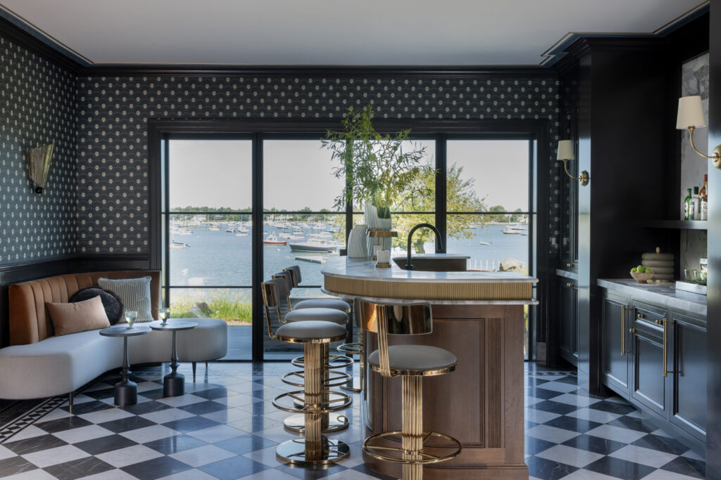 Yacht-inspired bar area with fluted wood, brass fixtures, and zinc countertop in Westchester coastal luxury estate.