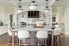 Modern kitchen interior with marble countertops, custom wood cabinetry, and brass fixtures designed by Mimi & Hill, a Westfield NJ interior design studio specializing in new construction and renovation.
