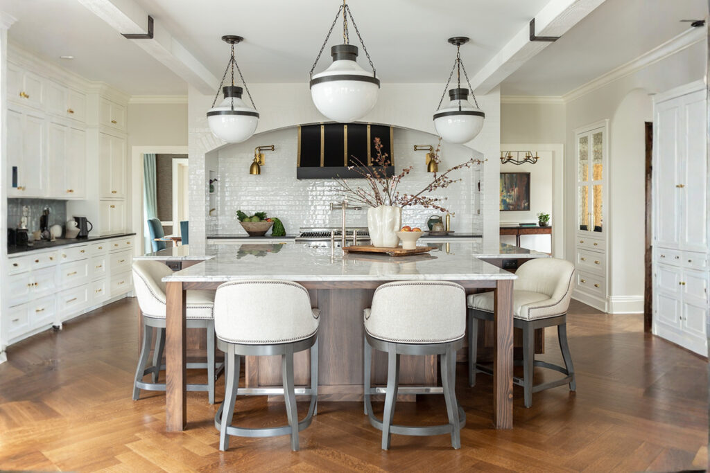 Modern kitchen interior with marble countertops, custom wood cabinetry, and brass fixtures designed by Mimi & Hill, a Westfield NJ interior design studio specializing in new construction and renovation.