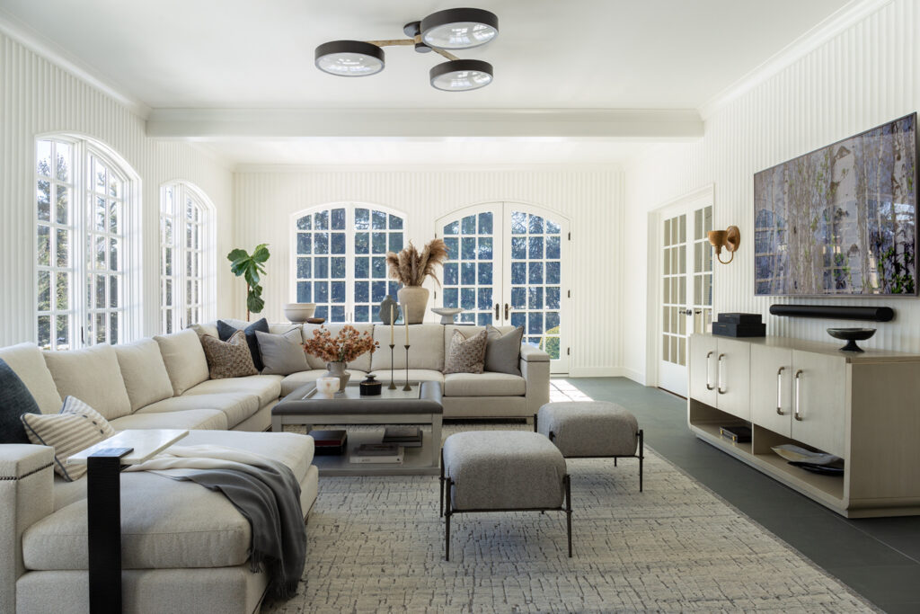 Transitional design living room with marble fireplace, custom millwork, and warm neutral color palette in Short Hills family home.