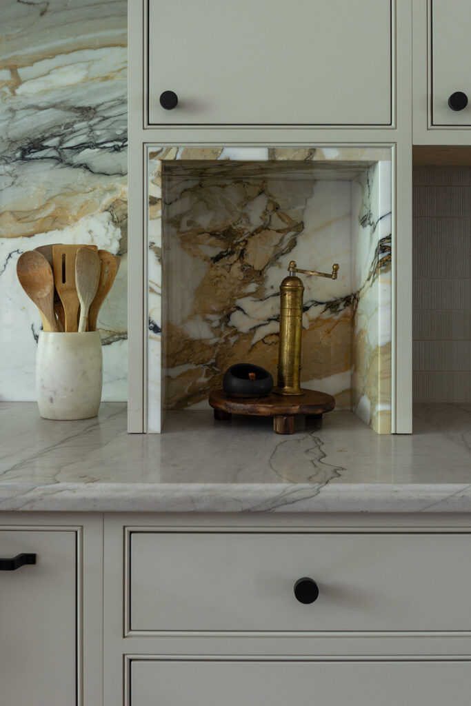 Kitchen quartz countertops, wall panels, and custom shaker cabinetry in a summit new jersey colonial farmhouse