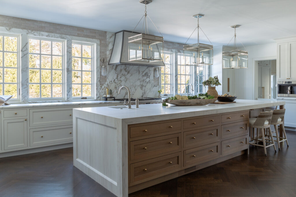 Transitional interior design kitchen with white oak island, quartzite counters, and modern cabinetry.