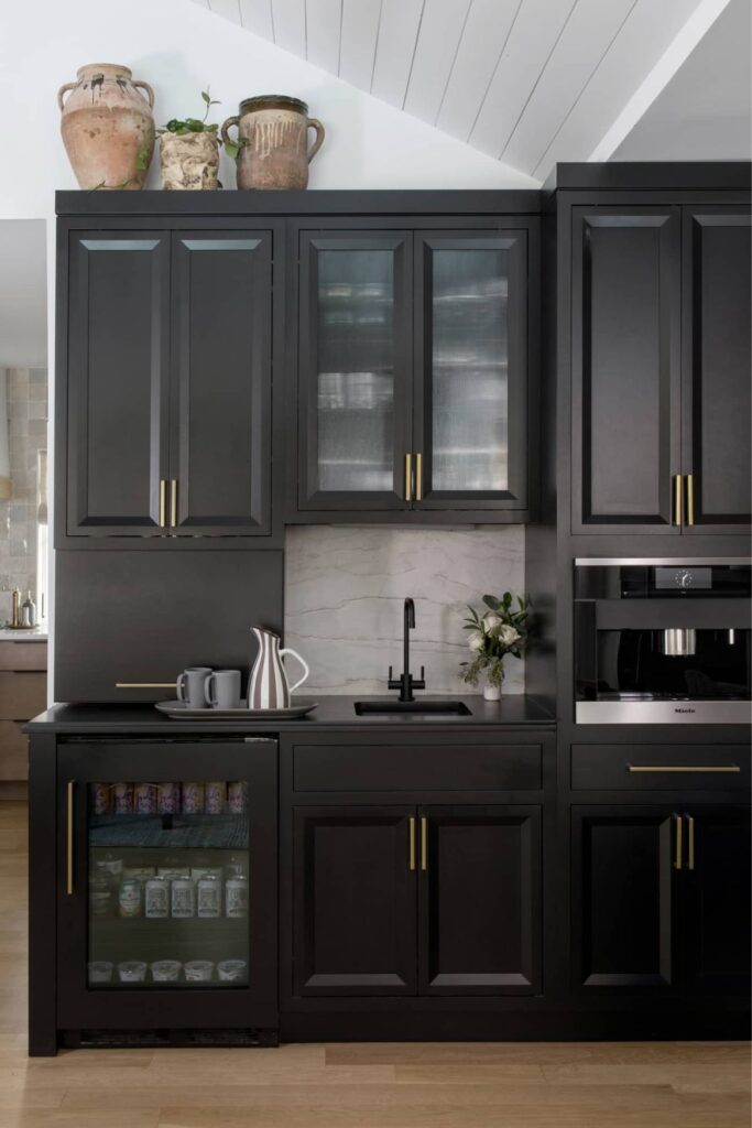 Dark kitchen cabinetry with integrated Miele microwave and built-in mini fridge in a modern Westfield NJ ranch renovation.
