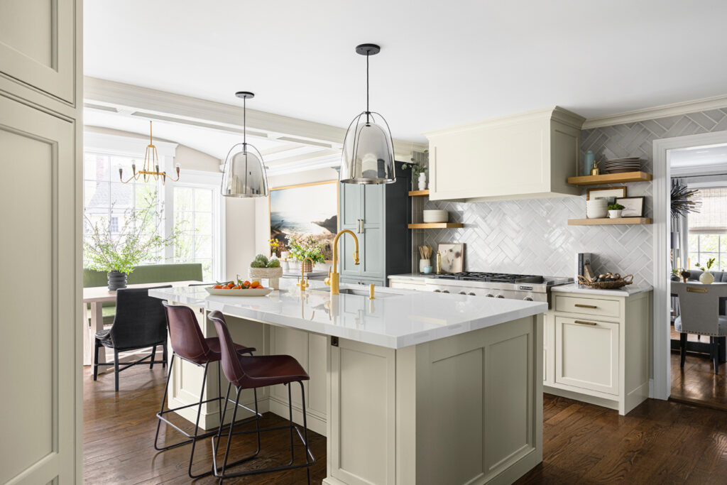Transitional kitchen in Westfield New Jersey featuring two-toned cabinetry with white perimeter units and a deep navy island, Carrara marble countertops, and a butler’s pantry.